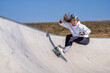 © Westend61 - Young woman practicing skateboarding in pump track on sunny day