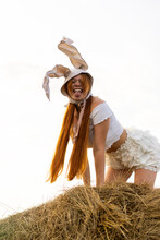 Playful Young Woman Wearing Rabbit Costume Showing Tongue