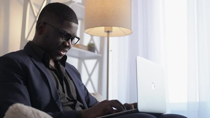Internet business. Work inspiration. Digital media. Joyful successful man entrepreneur typing online message on laptop enjoying freelance network at home copy space.