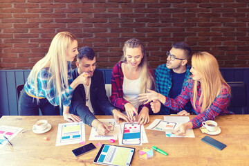 Graphic designers developing web page for mobile phone