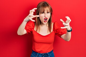 Poster - Redhead young woman wearing casual red t shirt shouting frustrated with rage, hands trying to strangle, yelling mad