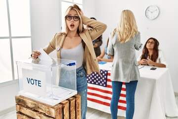 Canvas Print - Group of young girls voting at democracy referendum crazy and scared with hands on head, afraid and surprised of shock with open mouth