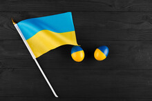Easter Egg With The Flag Of Ukraine On A Wooden Background.