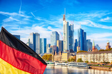 Skyline Cityscape Of Frankfurt, Germany During Sunny Day With German Flag. Frankfurt Main In A Financial Capital Of Europe.
