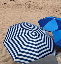 Open Bright Blue Beach Umbrellas On A Sandy Beach