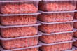 © Алексей Филатов - Minced meat in plastic packages on supermarket shelves. Selective focus