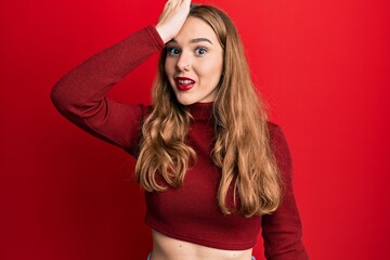 Canvas Print - Young blonde woman wearing turtleneck sweater surprised with hand on head for mistake, remember error. forgot, bad memory concept.