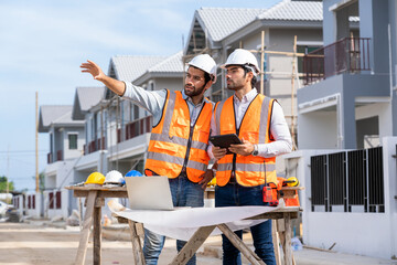Fototapete - Architect and engineer discussing planning for a building a new home at construction site,Architect watching some a construction,Business, Building,Industry,People concept.