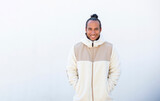 Fototapeta  - Happy man in winter jacket with hands in pocket over white background