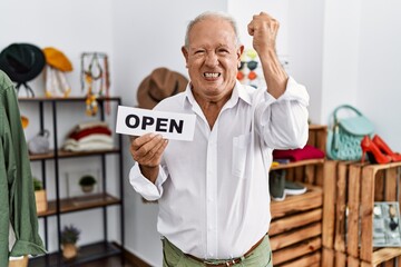 Wall Mural - Senior man holding banner with open text at retail shop annoyed and frustrated shouting with anger, yelling crazy with anger and hand raised