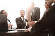 © ASDF - shaking hands after a business meeting in the office
