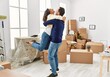 © Krakenimages.com - Middle age hispanic couple smiling happy and hugging at new home.