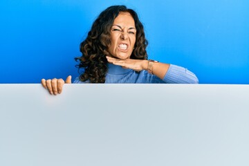 Sticker - Middle age hispanic woman holding blank empty banner cutting throat with hand as knife, threaten aggression with furious violence