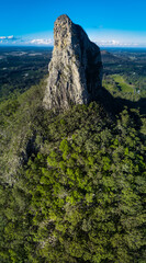 Wall Mural - Vertical aerial view of huge high rock among woods