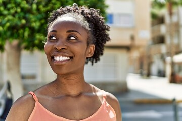 Canvas Print - Young african american woman smiling happy at the city on a summer day