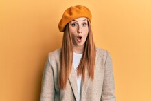 Young Irish Woman Wearing French Look With Beret Scared And Amazed With Open Mouth For Surprise, Disbelief Face