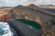 Aerial Panoramic View Of El Lago Verde (Green Lake) Along The Coast With Black Sand Beach Near El Golfo, Lanzarote, Canary Islands, Spain.
