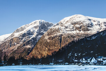 Wall Mural - Beautiful view of the mountains and buildings underneath during winter in Norway