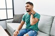 © Krakenimages.com - Young arab man suffering for neck pain sitting on sofa at home