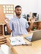 © Krakenimages.com - Young arab man doing yoga exercise at office