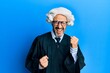 Middle age hispanic man wearing judge uniform celebrating surprised and amazed for success with arms raised and eyes closed
