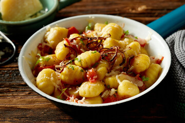 Sticker - Appetizing traditional Italian potato gnocchi served with stewed tomato fried onion and cheese