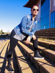 Vertical shot of a young woman in an urban fashion shoot