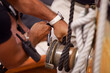 Sailor's hand adjusting ropes to hoist the sails of a boat