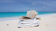 Beautiful shot of a towel and a book at a beach near the Indian ocean in the Maldives