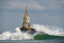 Old Rusty Lighthouse In The Black Sea With Giant Waves Crashing On It In Ahtopol, Bulgaria
