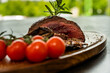 Selective focus shot of a stake and fresh tomatoes - tasty food