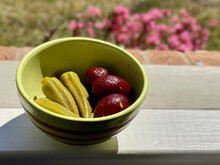 Closeup Shot Of A Green Bowl Of Pickled Okras And Bright Red Whole Beats On A Window Sill In Spring