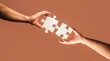 © Yevhen - Holding puzzle. Closeup hand of connecting jigsaw puzzle. Business solutions, success and strategy concept. Two hands trying to connect couple puzzle piece on yellow background. Teamwork concept