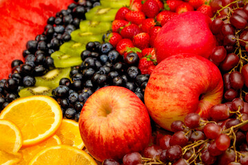 Fresh fruits concept, Arrangement of kiwi orange apple and assorted burry as background