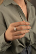 © Oguz - Young woman's hand wearing a diamond ring. wedding accessories bride.