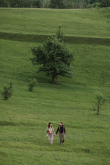 Romantic, young and happy caucasian couple in stylish clothes traveling together in the beautiful countryside nature. Love, relationships, romance, animal care, happiness concept.