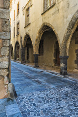 Wall Mural - Street with arcades, Grimaud Medieval village, Var, Provence region, France