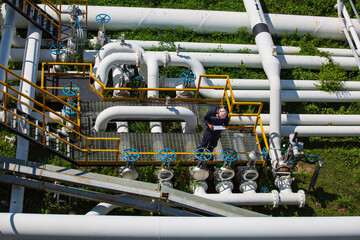 Wall Mural - Top view male worker inspection at valve of visual check record pipeline oil