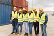© PintoArt - The group of engineers meeting shows the best team collaboration in the Container Yard, logistics workers team with protective helmet and reflective vest.