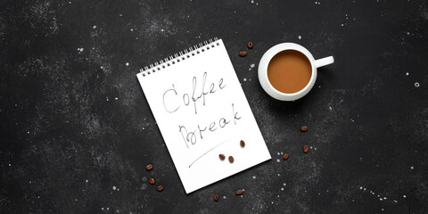 Wall Mural - Coffee break. A cup of coffee with an open notepad on a black stone background. Top view, banner.