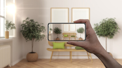 Wall Mural - hand holding smart phone, ar application, simulate furniture and interior design products in real ho
