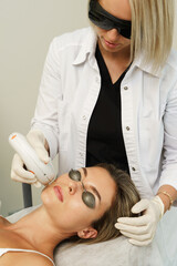 Poster - Woman client during IPL treatment in a cosmetology clinic