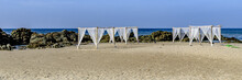 White Canopies On A Sandy Beach