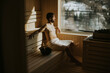 © BGStock72 - Young man relaxing in the sauna and watching winter forest through the window