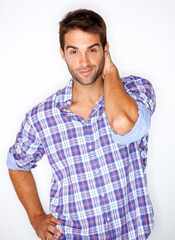 Poster - Casual modern charm. Handsome young guy in a check shirt with his hand behind his head against a white background.
