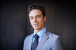 © Daniel L/peopleimages.com - Hes a cut above the rest. Portrait of a handsome young businessman in a suit standing indoors.