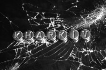 The Word Kharkiv On The Broken Glass. Abstract Photo.