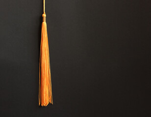 Wall Mural - Graduation concept with academical tassel on balck background
