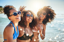 The Beach Sure Is A Beautiful Place To Be. Shot Of A Group Of Happy Young Women Having Fun Together At The Beach.