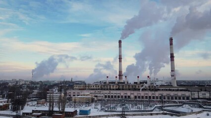 Wall Mural - Factory smokestack emissions at cloud winter snow landscape, climate change and global warming for the environment concept.